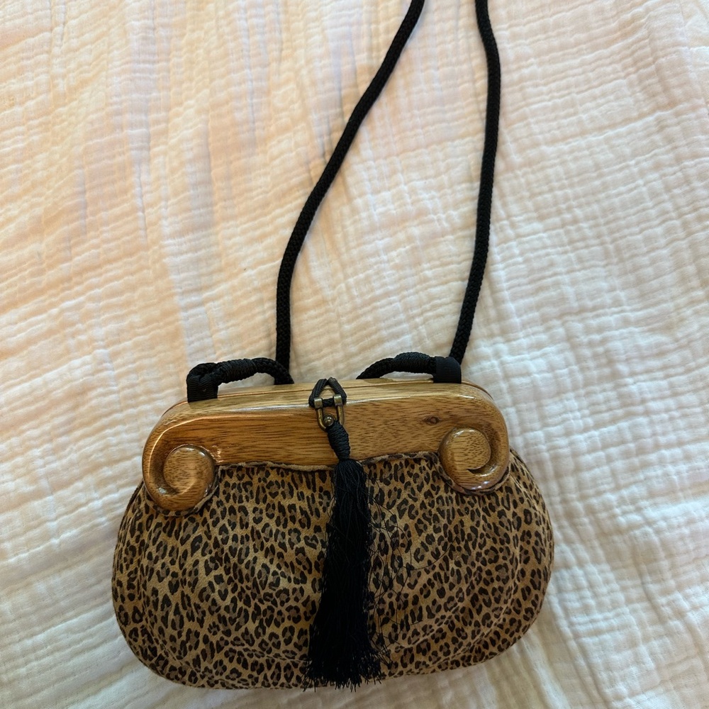 Timmy Woods hand carved acacia wood purse with leopard print and tassel detail